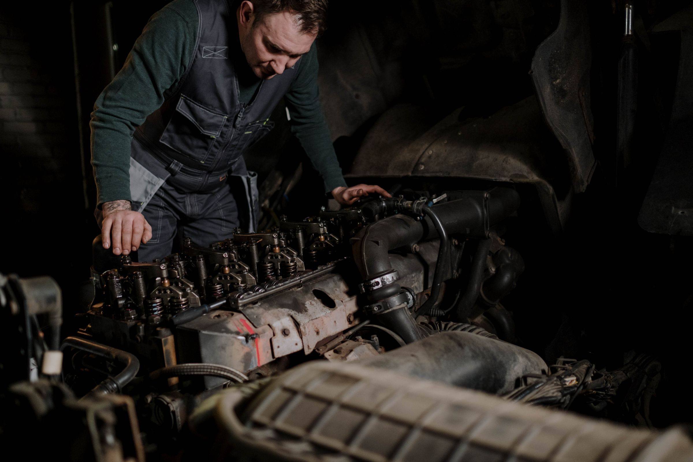 Technician working on a heavy-vehicle diesel engine